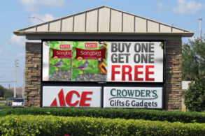 Electronic message center sign with roof accent and faux stone columns